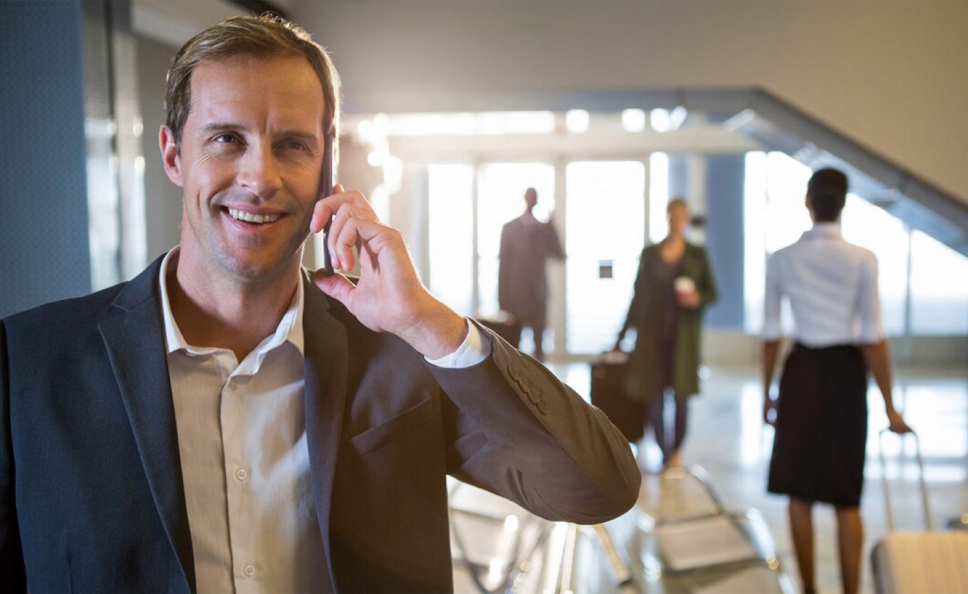 Businessman talking on the phone in a waiting room