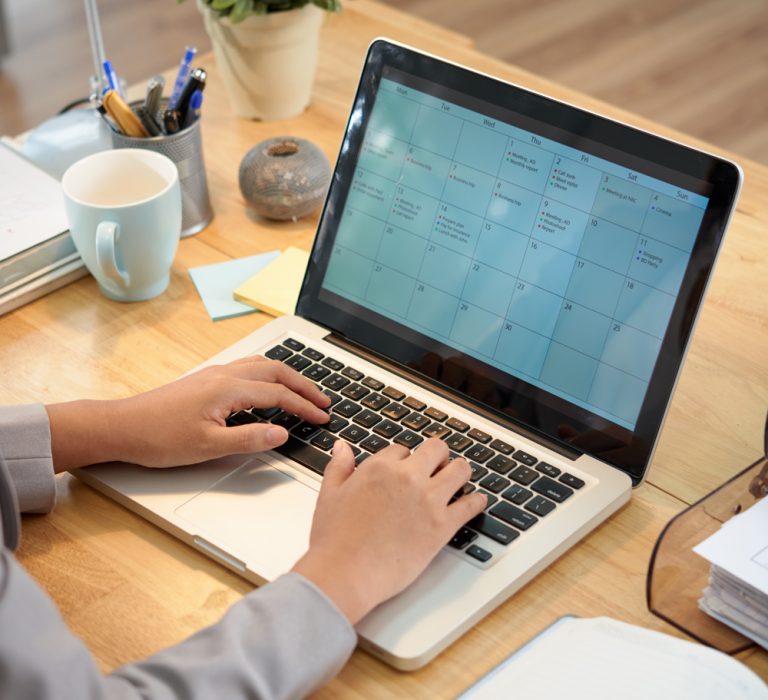 Business woman making schedule for the month